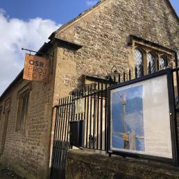 Noticeboard on railings outside of OSR Projects displaying digital drawing by Ella Kearvell