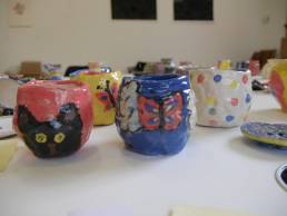 closeup of cat face painted on a hand made pot