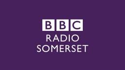 White BBC radio Somerset lettering on a purple background