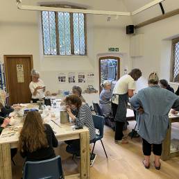 group of people working with clay at 2 tables in the OSR Projects studio