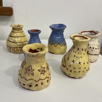 hand made coil pots painted yellow and blue