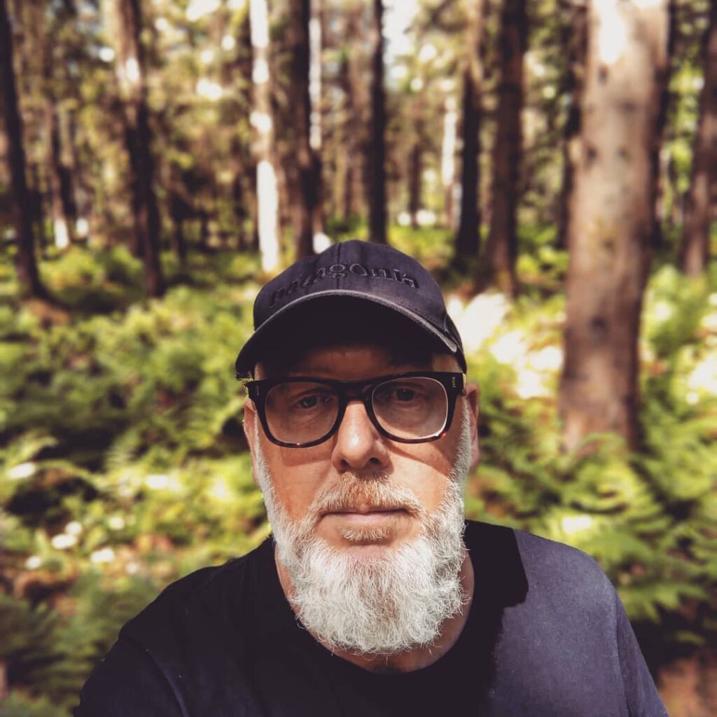 Al, male wearing a baseball hat and he has a white bears and wearing dark rimmed glasses.