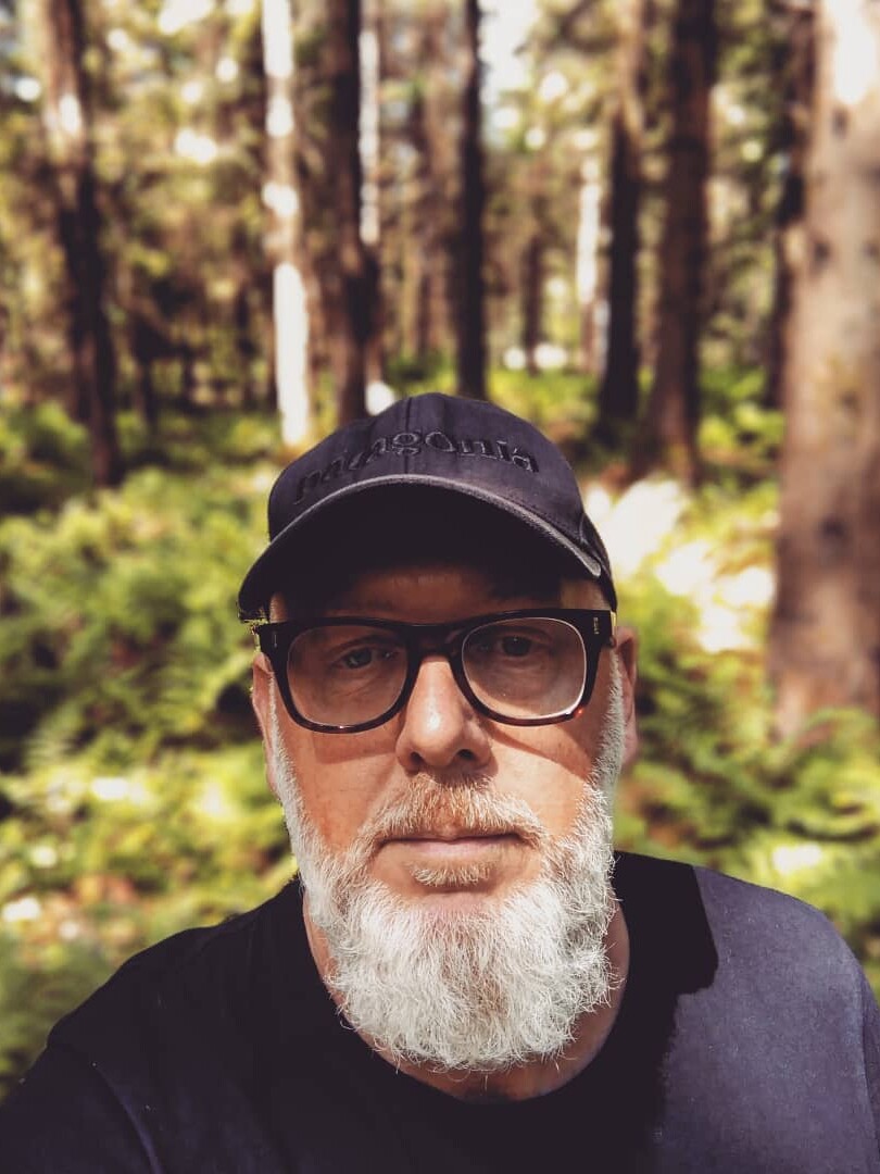 Al, male wearing a baseball hat and he has a white bears and wearing dark rimmed glasses.